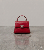 Crocodile textured handbag in red
