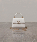 Crocodile textured handbag in white