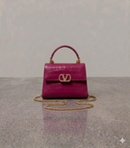 Crocodile textured handbag in dark pink